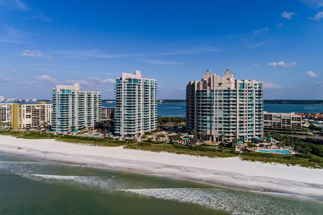 aerial view featuring a city view, a water view, and a beach view