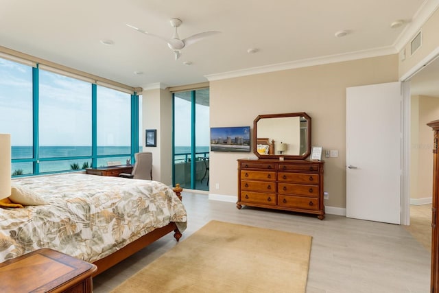 bedroom featuring access to outside, floor to ceiling windows, and ornamental molding