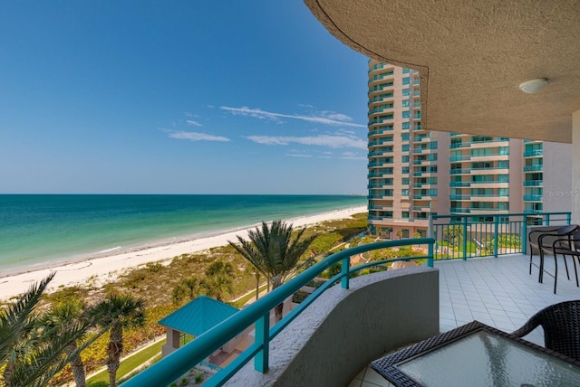 balcony with a beach view and a water view