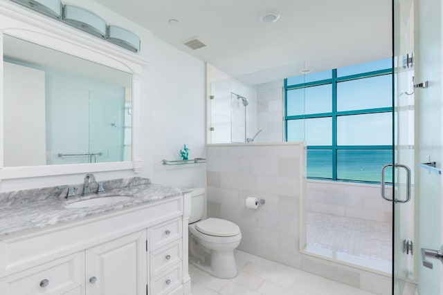 bathroom featuring toilet, a shower stall, visible vents, and vanity