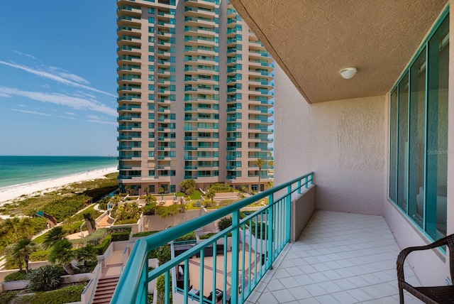 balcony with a water view and a beach view