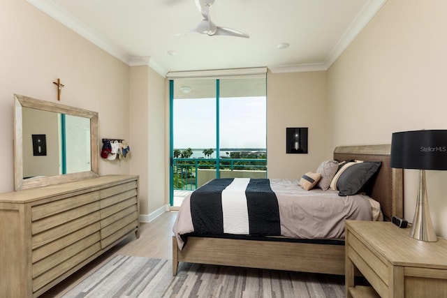 bedroom featuring light wood finished floors, baseboards, ornamental molding, access to outside, and floor to ceiling windows