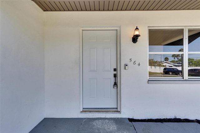 doorway to property with stucco siding