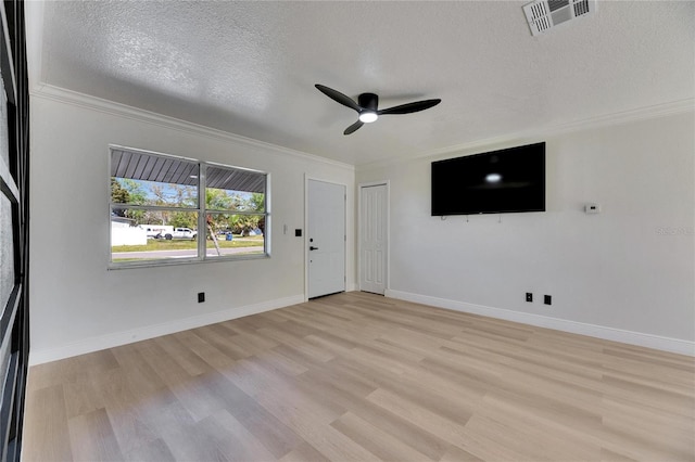 unfurnished living room featuring crown molding, visible vents, light wood-style floors, a textured ceiling, and baseboards