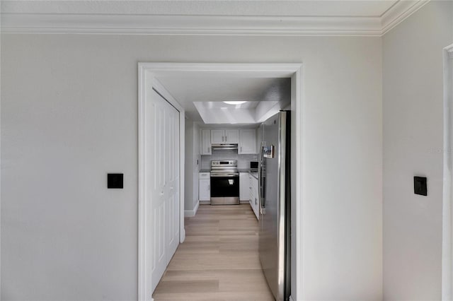 corridor featuring crown molding and light wood finished floors