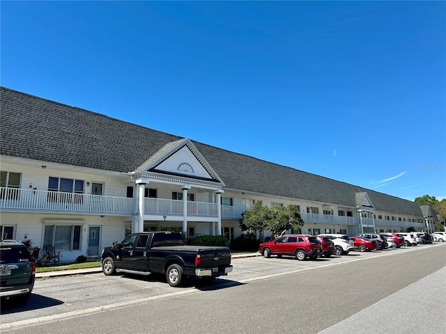 view of building exterior with uncovered parking