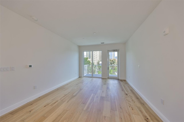 unfurnished room featuring light wood-style floors and baseboards