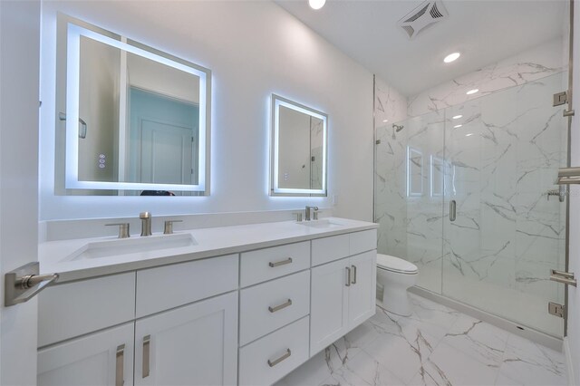 full bathroom featuring toilet, marble finish floor, a sink, and visible vents