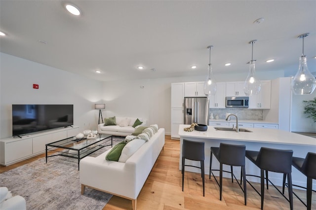 living room featuring light wood-type flooring and recessed lighting