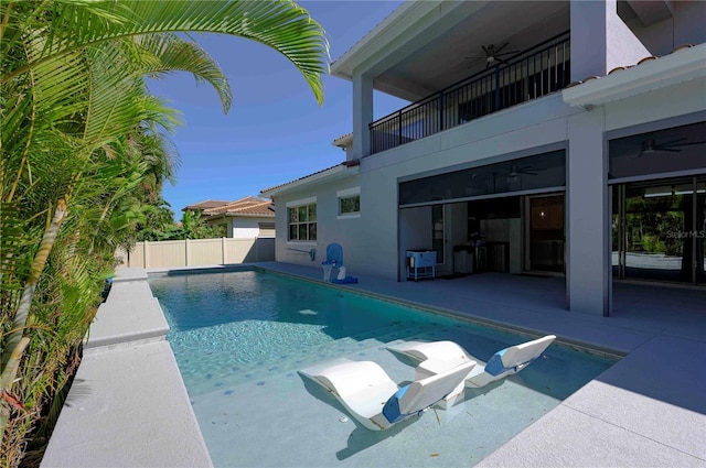 view of pool with a patio area, ceiling fan, fence, and a fenced in pool