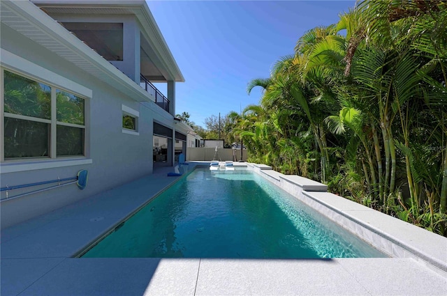 view of swimming pool featuring a fenced in pool, a patio, and fence