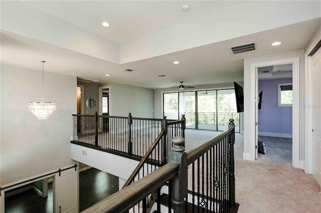 hallway with recessed lighting, light carpet, visible vents, an upstairs landing, and baseboards