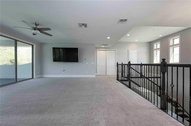 empty room featuring carpet floors, recessed lighting, visible vents, and baseboards