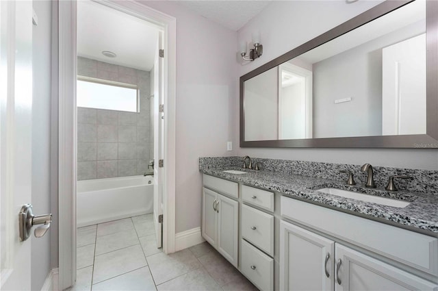 full bathroom with double vanity, tile patterned flooring, bathtub / shower combination, and a sink