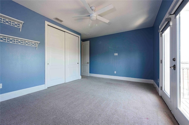 unfurnished bedroom featuring visible vents, baseboards, ceiling fan, carpet floors, and a closet