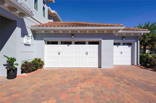 garage with decorative driveway