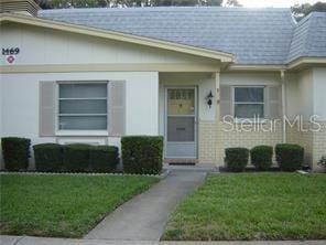 view of exterior entry with a lawn