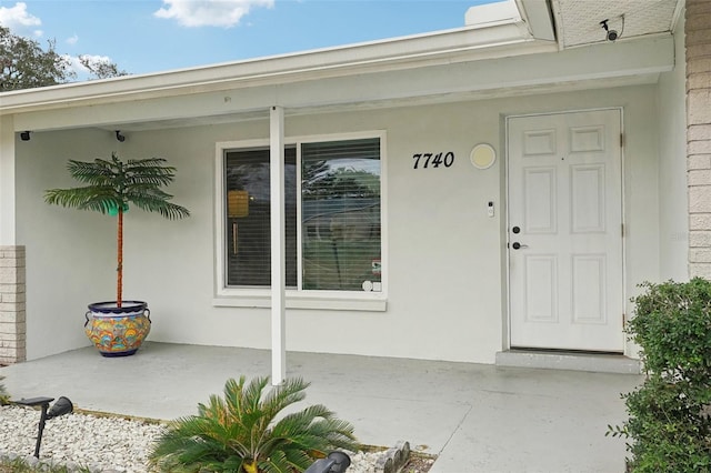 property entrance with stucco siding