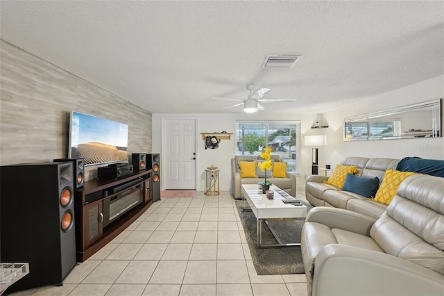 7740 Bracken Dr, Port Richey, FL 34668 - living area featuring visible vents, ceiling fan, a textured ceiling, and light tile patterned floors