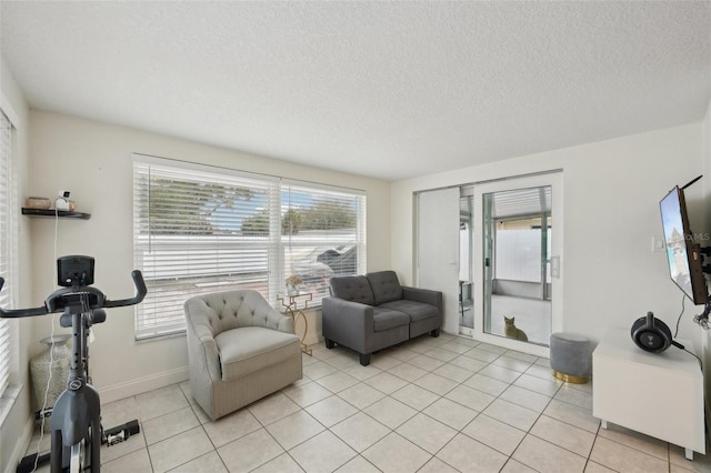 7740 Bracken Dr, Port Richey, FL 34668 - living area with light tile patterned floors, a textured ceiling, and baseboards