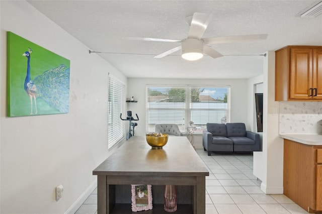 7740 Bracken Dr, Port Richey, FL 34668 - dining area featuring light tile patterned floors, a textured ceiling, visible vents, baseboards, and a ceiling fan