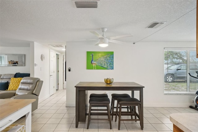 7740 Bracken Dr, Port Richey, FL 34668 - dining area with a textured ceiling, visible vents, and a ceiling fan