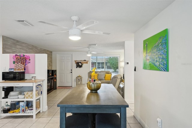 7740 Bracken Dr, Port Richey, FL 34668 - dining room with visible vents, ceiling fan, baseboards, and light tile patterned flooring