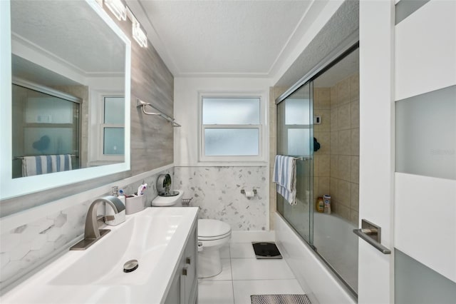 7740 Bracken Dr, Port Richey, FL 34668 - full bath featuring bath / shower combo with glass door, toilet, tile patterned floors, a textured ceiling, and vanity
