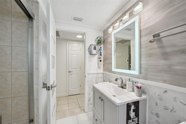 7740 Bracken Dr, Port Richey, FL 34668 - bathroom featuring tile patterned flooring, visible vents, a textured ceiling, and vanity