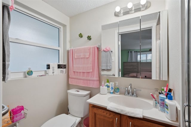 7740 Bracken Dr, Port Richey, FL 34668 - bathroom with a textured ceiling, toilet, and vanity