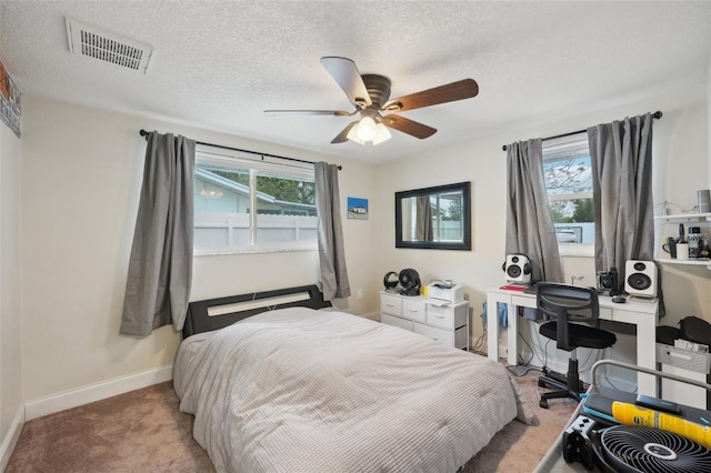 7740 Bracken Dr, Port Richey, FL 34668 - bedroom with carpet floors, multiple windows, visible vents, and a textured ceiling