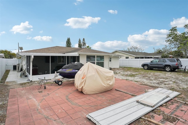 7740 Bracken Dr, Port Richey, FL 34668 - exterior space with a sunroom, a fenced backyard, stucco siding, and a patio