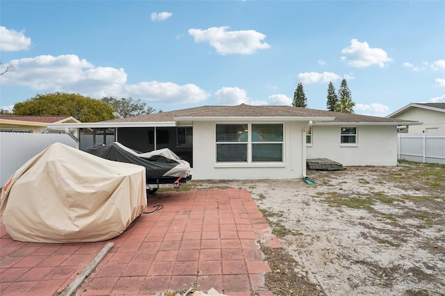 7740 Bracken Dr, Port Richey, FL 34668 - rear view of property featuring a patio area, fence, a sunroom, and stucco siding