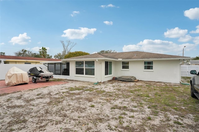 7740 Bracken Dr, Port Richey, FL 34668 - back of property featuring a patio area, fence, and stucco siding