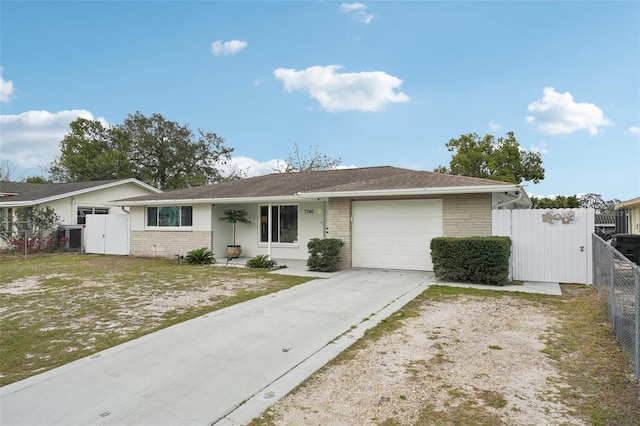 7740 Bracken Dr, Port Richey, FL 34668 - ranch-style home featuring an attached garage, brick siding, fence, concrete driveway, and a gate