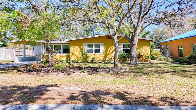 view of front of property featuring a front lawn and fence