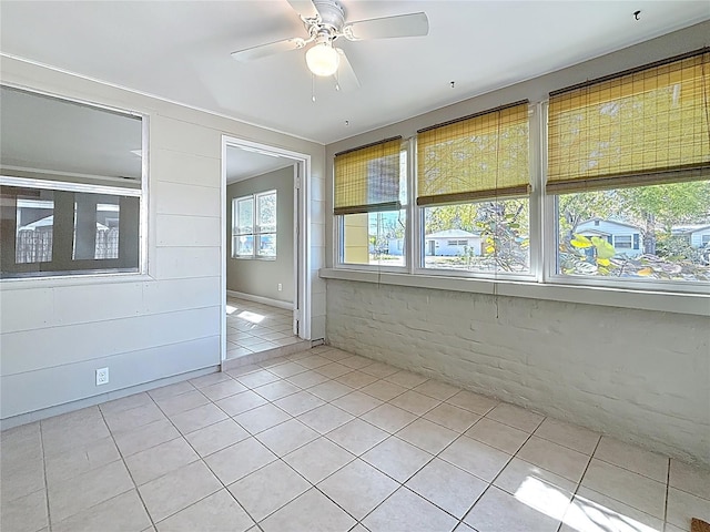 empty room with light tile patterned floors and ceiling fan