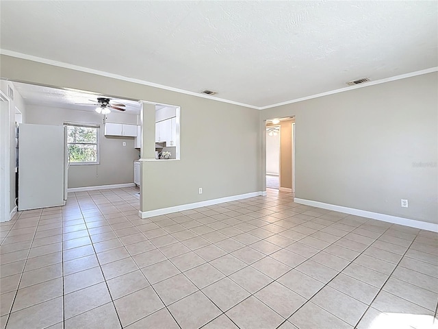 empty room featuring ornamental molding, visible vents, and light tile patterned floors