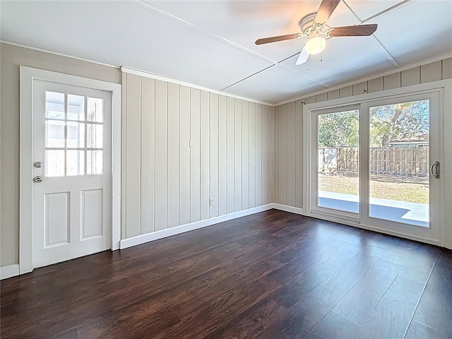 interior space with dark wood-type flooring, ceiling fan, and baseboards