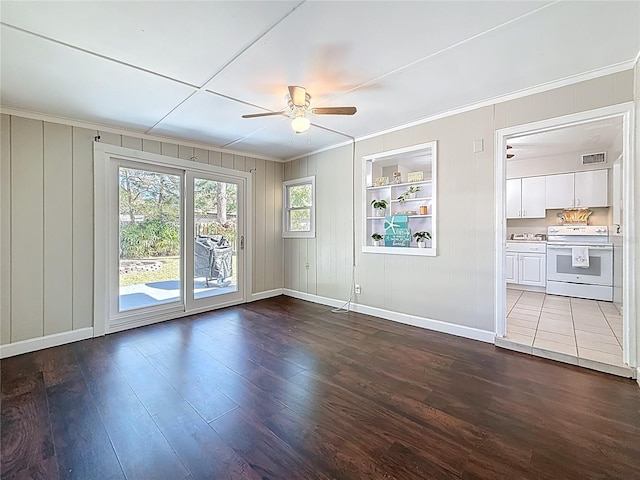 interior space with dark wood-style floors, built in features, crown molding, visible vents, and a ceiling fan