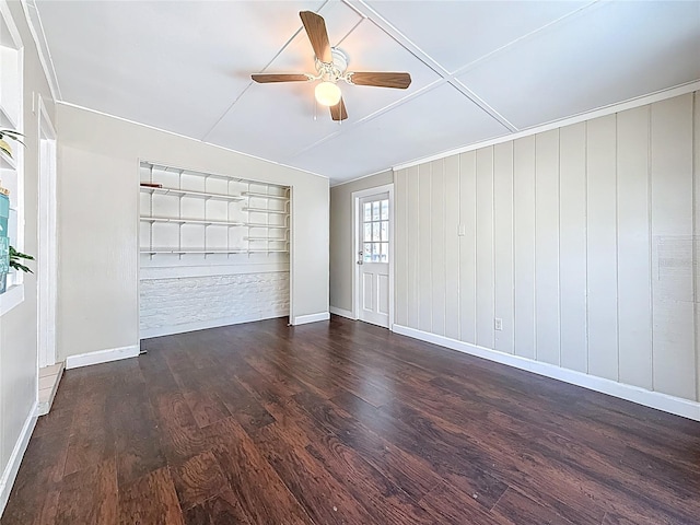 spare room featuring ceiling fan, wood finished floors, and baseboards