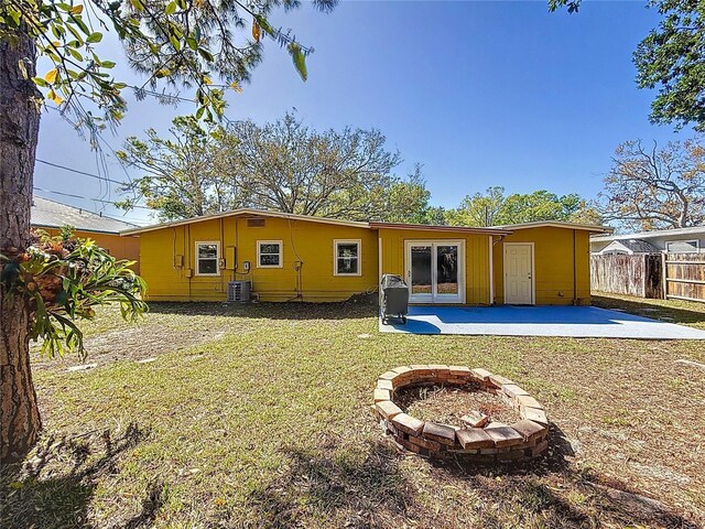 back of house with an outdoor fire pit, fence, a yard, french doors, and a patio area