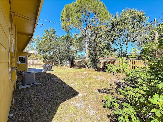 view of yard featuring central AC, a patio, and a fenced backyard