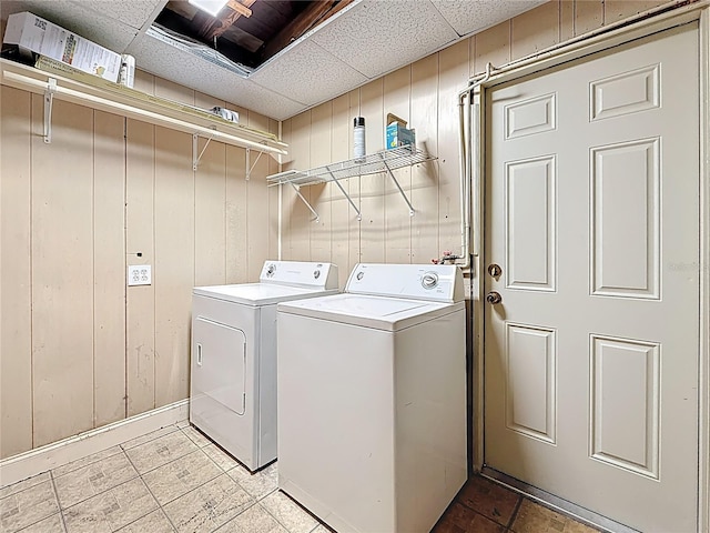 laundry room featuring laundry area, independent washer and dryer, and wooden walls