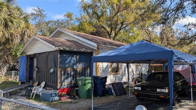 view of outbuilding with a detached carport and fence