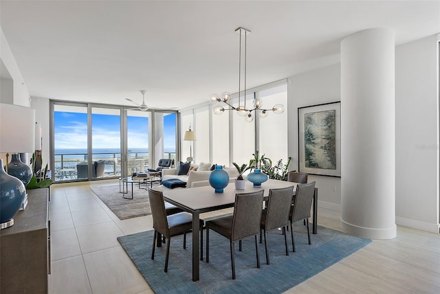 dining room featuring light tile patterned flooring, expansive windows, baseboards, and ceiling fan with notable chandelier