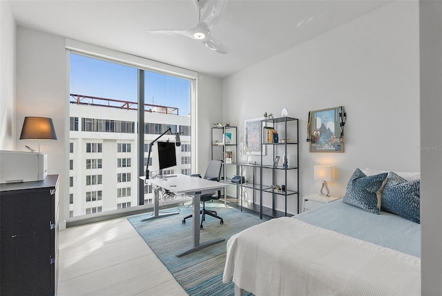 bedroom featuring ceiling fan and expansive windows