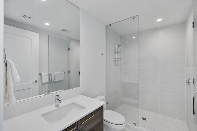 bathroom featuring visible vents, a shower stall, and toilet