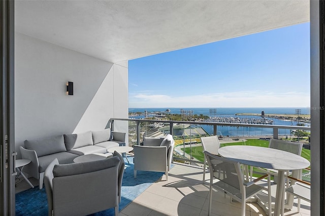 balcony with a water view and an outdoor living space