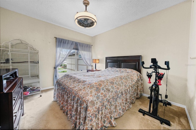 carpeted bedroom with a textured ceiling and baseboards